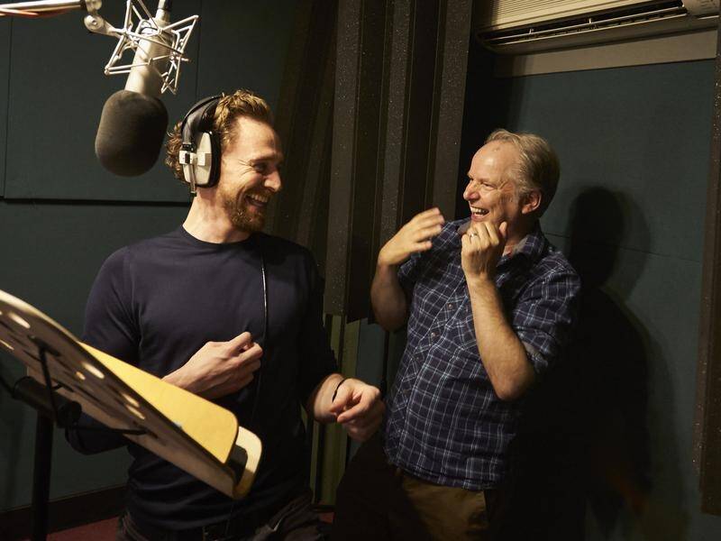 Tom Hiddleston (left) jokes with director Nick Park in the vocal booth for animated film Early Man.