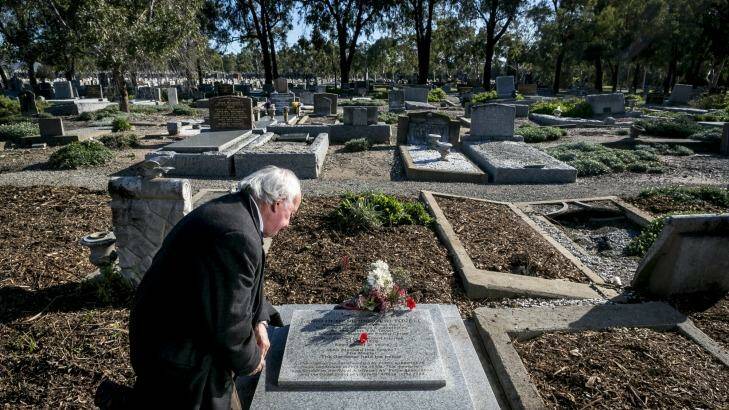 Anthony Hill, author of the new book Young Digger, pictured at Fawkner cemetery, Melbourne, at the grave of Henri Hemene Tovell, the French orphan smuggled from Europe by Australian airmen after World War I. Photo: Eddie Jim