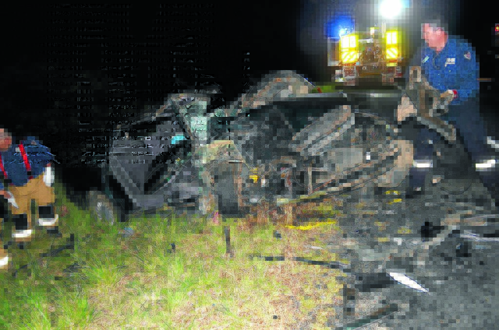 HORRIFIC CRASH: Emergency services work to clear the crash scene on the New England Highway near Uralla on Monday night.