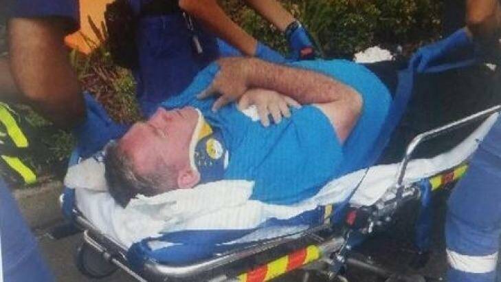 Ryde Mayor Bill Pickering is taken from the meeting by stretcher. Photo: Twitter