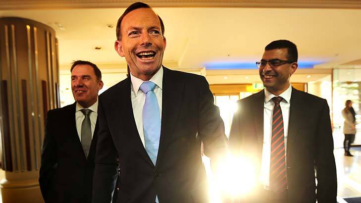 Prime Ministerial smile: Tony Abbott puts a brave face on things on Friday. Photo: Kate Geraghty