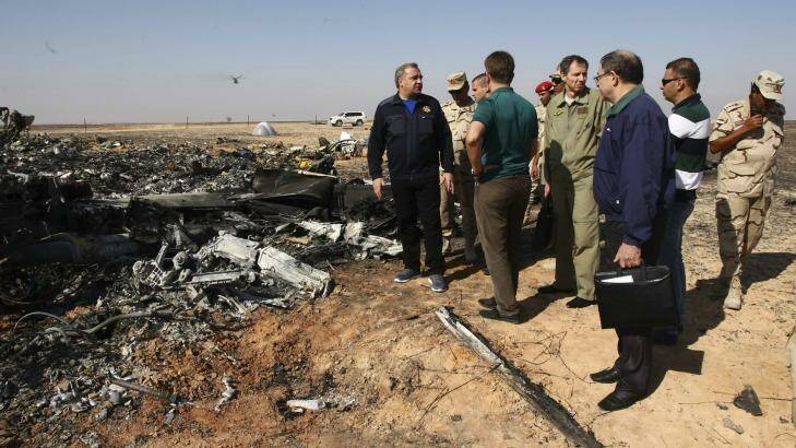 Russian Emergency Situations Minister Vladimir Puchkov, left, talks with Russian Transport Minister Maxim Sokolov, fifth right, as they inspect the wreckage of a passenger jet bound for St. Petersburg that crashed in Egypt. Photo: Maxim Grigoriev/AP