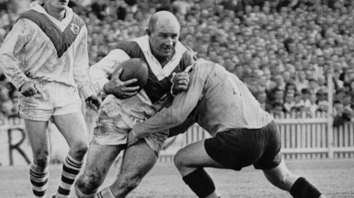Simpler times: St George’s Brian Clay shrugs off a classic one-on-one tackle during the 1966 grand final. Photo: Fairfax Archives