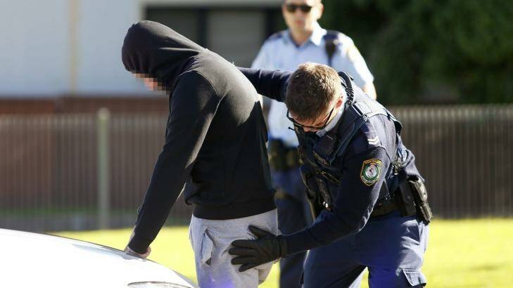 Police officers stopped various cars for searches as detectives raided homes on Gowrie Avenue at Punchbowl. Photo: Daniel Munoz