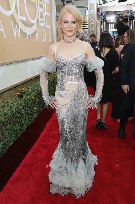 Nicole Kidman is taking a risk in  McQueen. The dress is a sheer grey mermaid gown with puffed gloves sleeves. Photo: Getty/NBC Universal