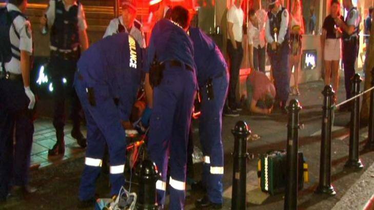 Paramedics treat Patrick Lyttle while brother Barry kneels in background (in red shirt) Photo: Seven News