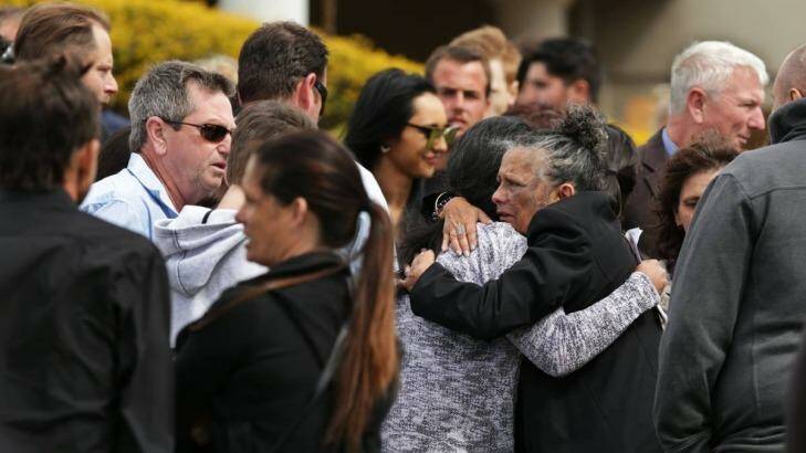Farewelled: Carly McBride's mother Lorraine Williams (right) hugs a mourner following the funeral of her slain daughter. Photo: Simone De Peak