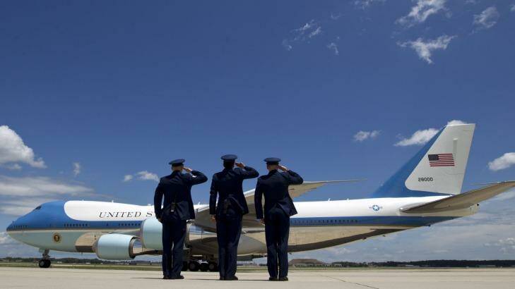 Military personnel salute as Air Force One, with President Barack Obama and Democratic presidential candidate Hillary Clinton aboard, departs Joint Base Andrews, Maryland, in July. Photo: AP Photo