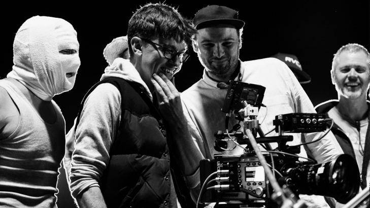 On the set of <i>Down Under</i>, director Abe Forsythe (second from left) watches a take with actor Justin Rosniak, director of photography Lachlan Milne and stunt co-ordinator Tony Lynch. Photo: David Dare Parker