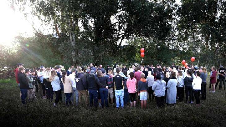 Family and friends pay tribute to Spencer at the crash site on Sunday. Photo: The Border Mail