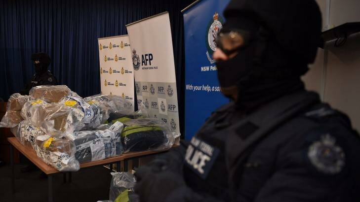 AFP officers stand guard over some of the 500 kilograms of cocaine seized during the Christmas Day bust in NSW. Photo: Kate Geraghty