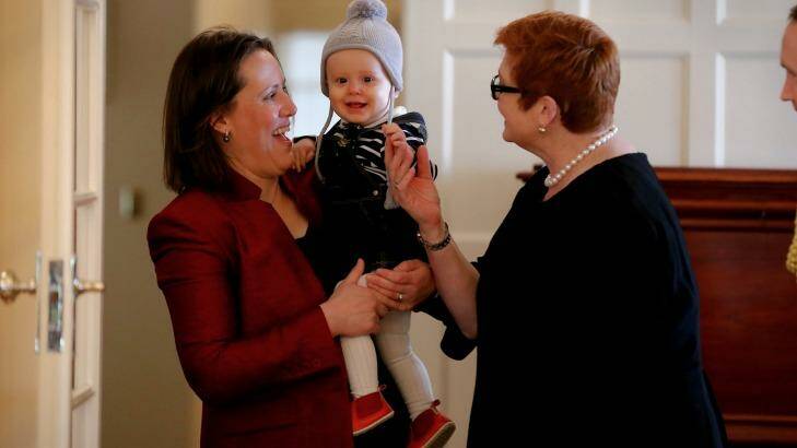Minister for Revenue and Financial Services Kelly O'Dwyer with daughter Olivia and Defence Minister Marise Payne during the ceremony. Photo: Alex Ellinghausen