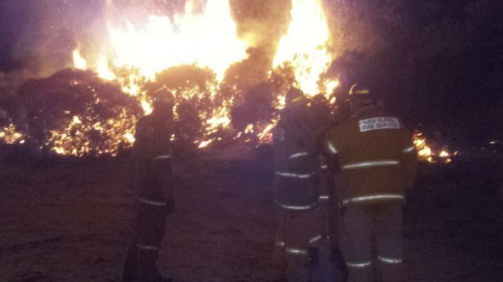 NSW Firemen keep a vigil on a fire at Wentworth Falls in the Blue Mountains. Photo: TNV News