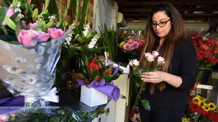 Florist Rita-Savannah Sakr at work in her garage after she had to close her shop when she wasn't paid by an online flower ordering company. Photo: Steven Siewert