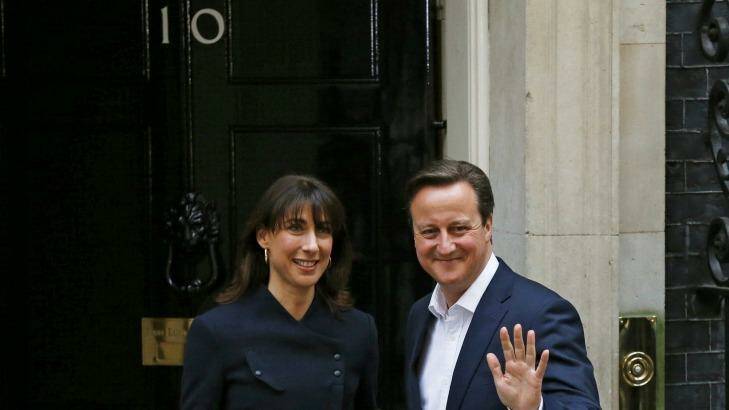 Britain's Prime Minister David Cameron waves as he arrives with his wife Samantha at 10 Downing Street, London, on Friday. Photo: Phil Noble