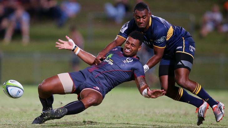 Samu Kerevi of the Reds is tackled by Tevita Kuridrani of the Brumbies during the Super Rugby preseason match at Ballymore. Photo: Chris Hyde