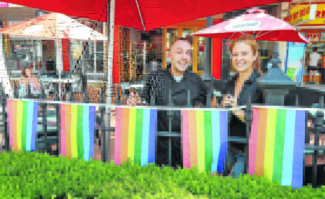 OUT AND PROUD: Chef Will Pigot and owner Kristy Sollars fly rainbow flags of gay pride at The Inland Cafe. Photo: Barry Smith 201114BSE05