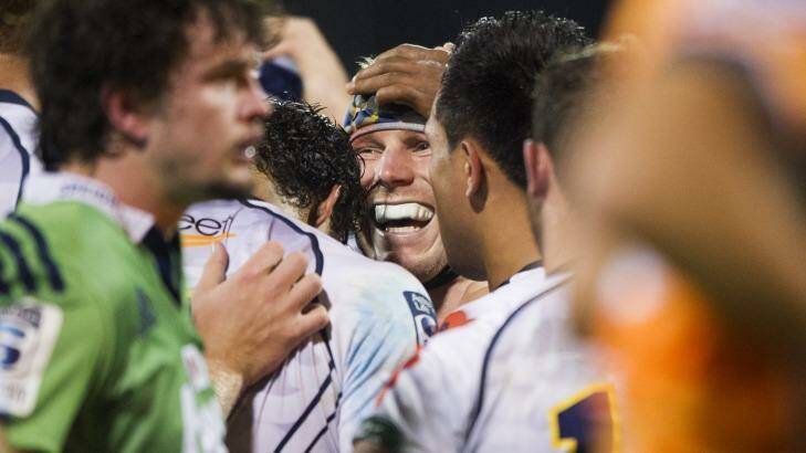 Brumbies player David Pocock is congratulated after scoring one of his three tries against the Highlanders. Photo: Matt Bedford