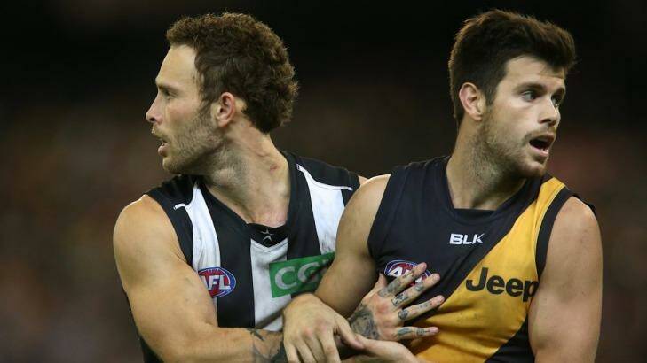Brent Macaffer and Trent Cotchin tussle at the MCG on Friday night Photo: Pat Scala