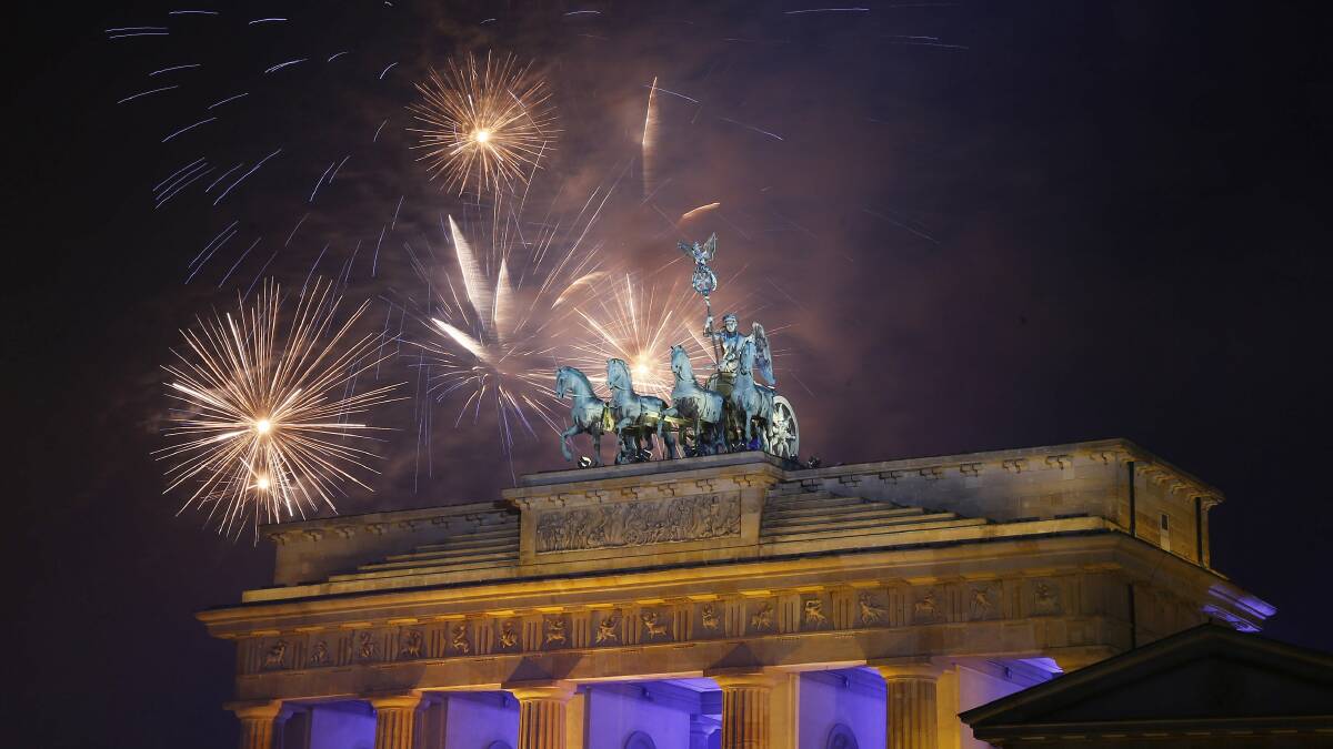 GERMANY: Fireworks explode next to the Quadriga sculpture atop the Brandenburg gate during New Year celebrations in Berlin. Photo: REUTERS
