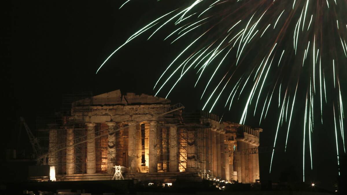 GREECE: Fireworks explode over the temple of the Parthenon atop the Acropolis hill during New Year's Day celebrations in Athens. Photo: REUTERS