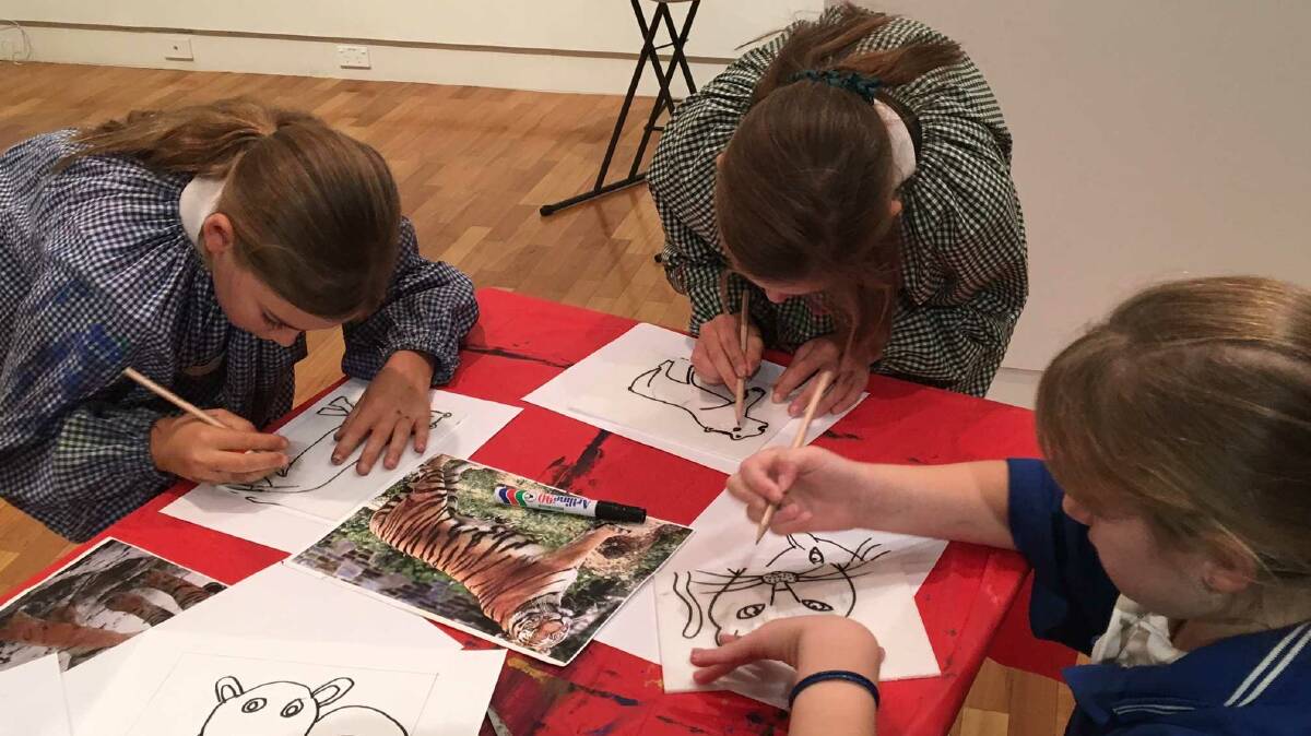 Eve Porter, Jayde Smith and Sienna Cronin preparing their drawing for ink printing