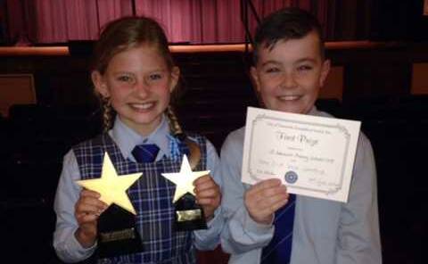 St Edward’s Lily Vine and Charlie Maloney with the Year 4 division win certificate and the overall outstanding performance of the Eisteddfod trophy.
