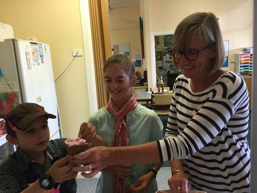 Wallabadah school captains, Aiden MacMurray and Jayde Smith, served ice creams with Mrs Cudmore as part of their fundraiser