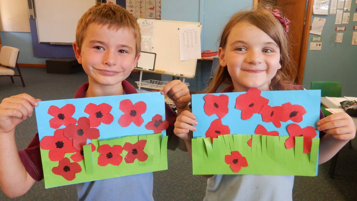 Attunga’s K-2 students Damian Simon and Lilly Reinikka with their poppy art for Remembrance day