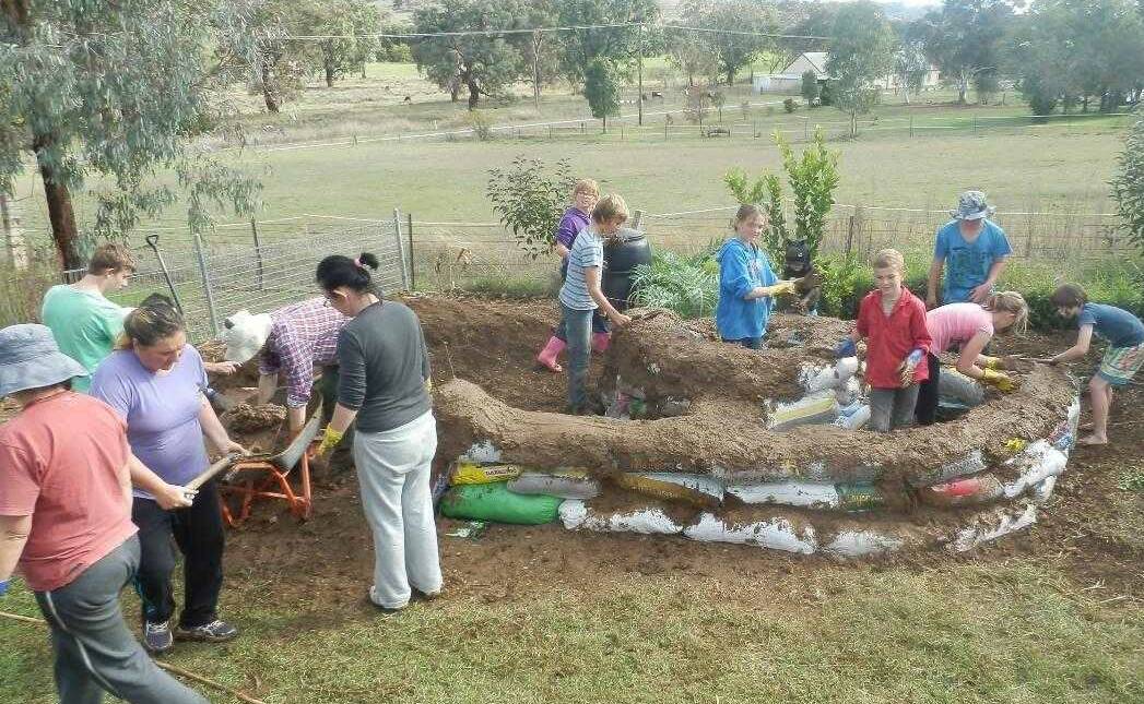 The working bee at Dungowan PS built a snail-shaped 'Earth Bag Herb Spiral' garden.