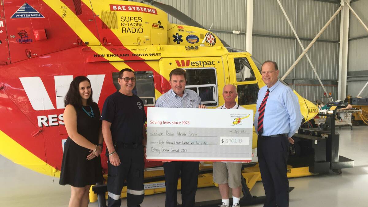 
The Westpac Rescue Helicopter Services’ Taylor Fletcher and pilot, Dave Davies, receive a cheque from Calrossy Anglican School’s combined P & F chairperson, Stuart Watts, Head of Primary, Robert Black, and Head of Secondary Boys, Joe Goldsworthy
