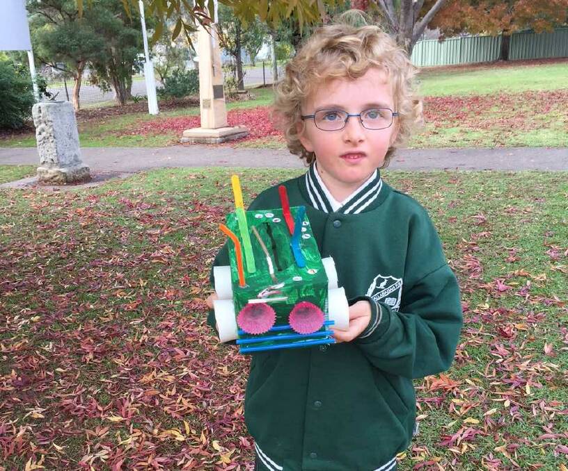 Chloe Dent from K-2S pictured with the car she made as part of their Transport Unit.
