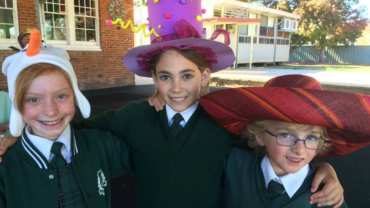 Natalie Payne, Eve Porter and Chloe Dent wearing their hats for the Wallabadah Mad Hatter's Tea Party.