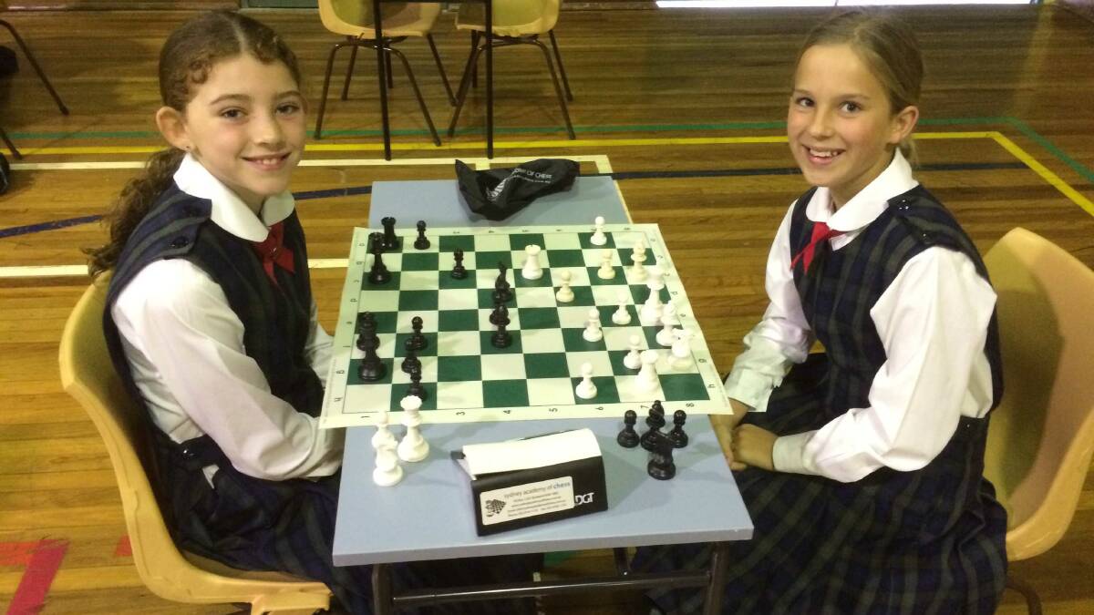 Calrossy’s Abbie Lewis and Tahlia Barwick making their move at the Interschool Chess Competition in Manilla