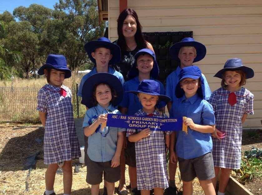 A big Tamworth Show ribbon for a small school. Moonbi teacher Miss Kristin Reilly with her gardeners, back from left: Taylor Whalan, Charlie Hartshorn, Sean Eccleston, Riley Smith and Lauren Robertson. Front Seth Casey, Tahlia Sullivan and Lincoln Hunt