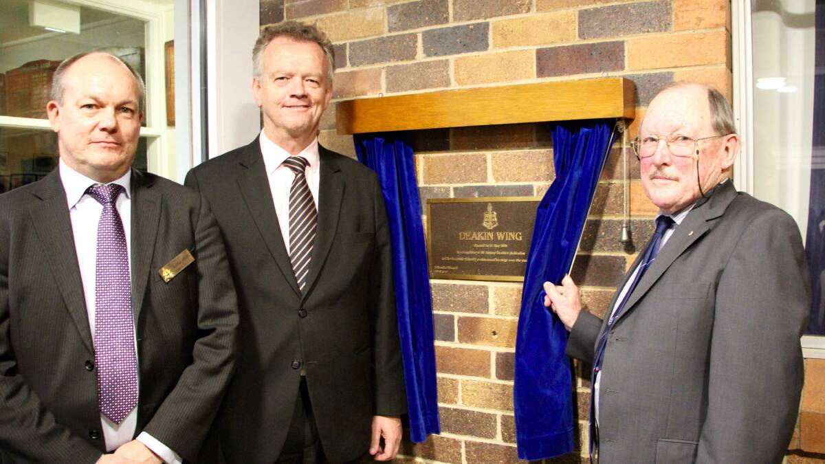 The Armidale School’s chairman Sebastian Hempel and headmaster Murray Guest watch as Tony Deakin (right) unveils a plaque commemorating a new residential wing named after him at TAS.