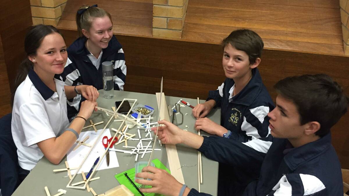 Charlotte George, Dimity Tearle, Henry Smith and Angus Haire work on their bridge that won one of the challenges at UNE on March 16