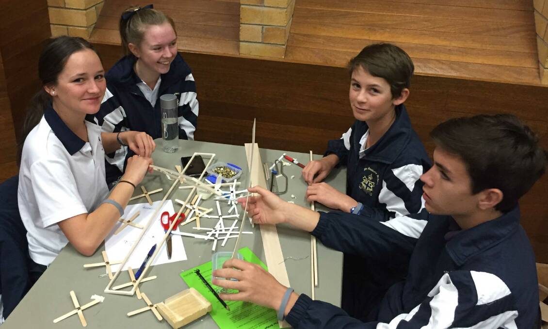Charlotte George, Dimity Tearle, Henry Smith and Angus Haire work on their bridge that won one of the challenges at UNE on March 16.