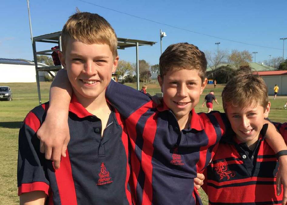Hunter Dalzell (l), Hamish McPherson and Matthew Holmes are all smiles and sportsmanship at Calrossy's Secondary Boys athletics carnival