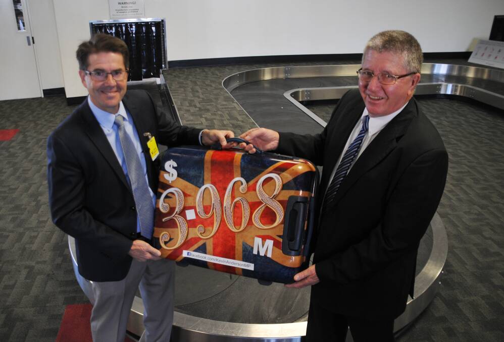 CABIN BAGGAGE: Kevin Anderson symbolically presents Col Murray with the government funding.