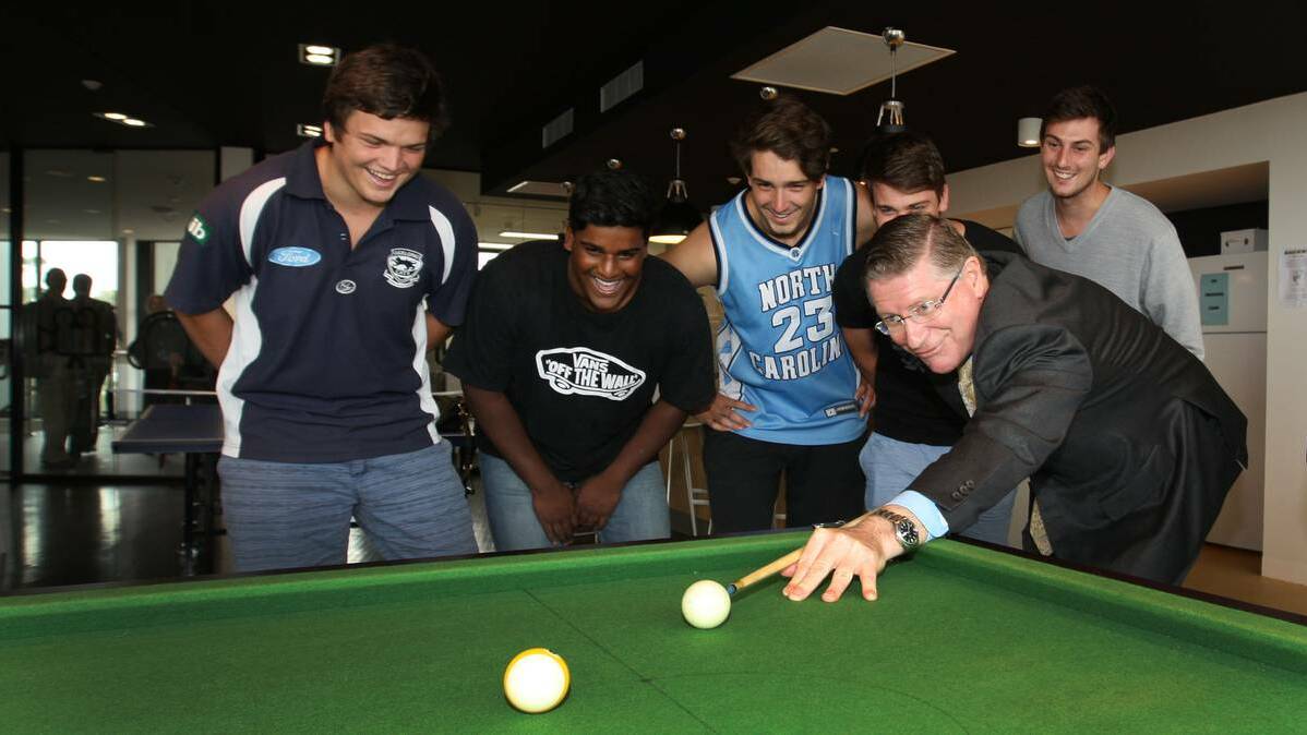 Victorian Premier Denis Napthine shows his pool skills to students at the opening of Deakin University's new residences. Picture: ANGELA MILNE, The Standard.