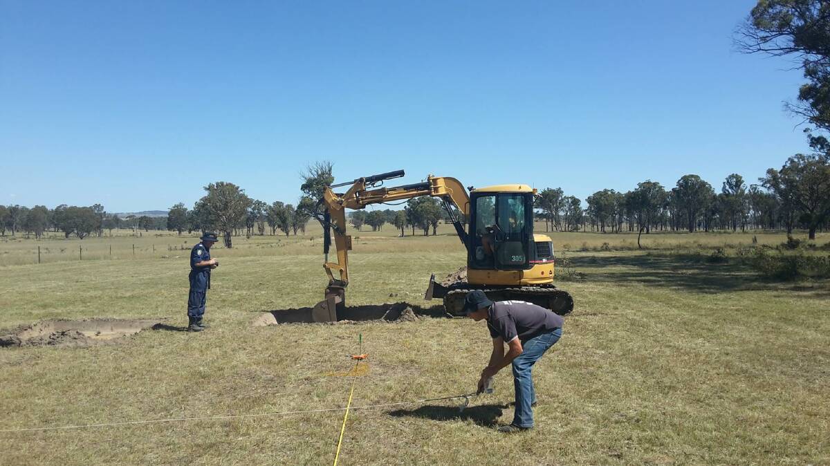 POLICE PROBE: An excavator and investigators comb a property on the outskirts of Armidale last week, searching for clues to the suspicious disappearance of Bill Roach. Photo: NSW Police 