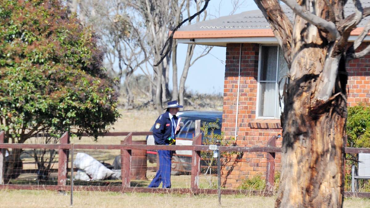 SCENE OF THE CRIME: A police officer stands guard at the Castledoyle Rd home where Collins was arrested in August last year. Photo: Geoff O'Neill