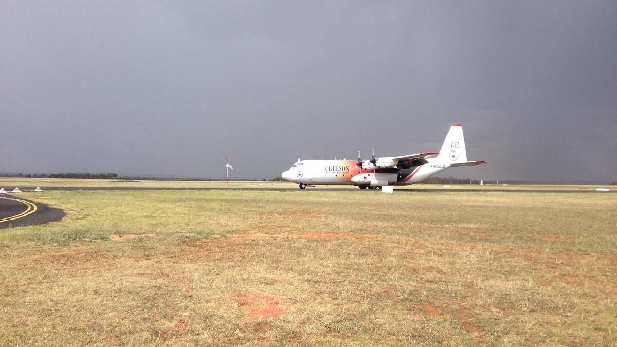 AIR ATTACK: NSW RFS volunteers from the Dubbo area worked to reload 'Thor' at Dubbo airport yesterday afternoon. Photo: Ashley Waugh NSW RFS