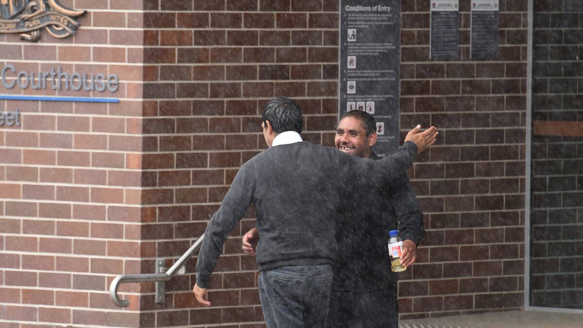 FREE: Samuel Boney, left, and Brian Boney celebrate outside Armidale court after escaping jail for their parts in the bashing of two Glen Innes police officers. Photo: Gareth Gardner 280116GGA04