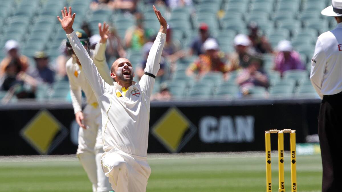 Australia's Nathan Lyon, left, appeals for a LBW decision to umpire Ian Gould, right, during the third day of their cricket test match against India in Adelaide, Australia, Thursday, Dec. 11, 2014. Australia declared their fist innings at 517 for 7.  Photo: James Elsby.