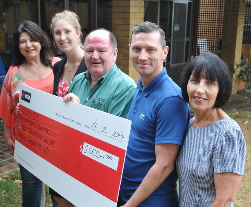 GIFT OF GIVING: Tamworth hospital management accountant Libby Gruszynski, second from left, accepts a cheque from Addimi owners Michael Coffey (middle), his son Adrian and wife Dianne – while Country Music Capital News managing editor Cheryl Byrnes, left, looks on.  140214DJA02