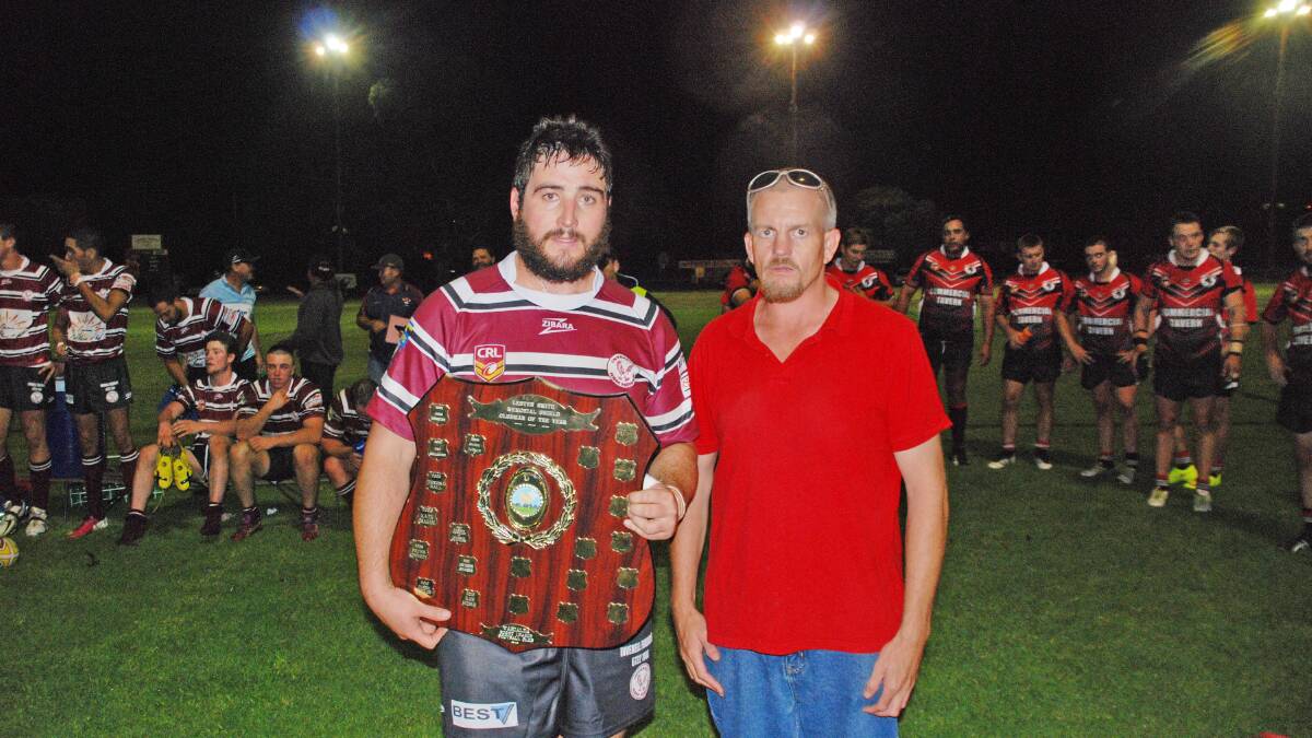 It wasn’t quite the Jim Payne Cup but Inverell Hawks captain Alex McCosker holds  a fill-in trophy for the Cup when presented with the inaugural winning of the Jim Payne Cup by Warialda Rugby League Football Club president Adrian Kellett at Warialda on Friday night. Photo: Geoff Newling 100415GNA02