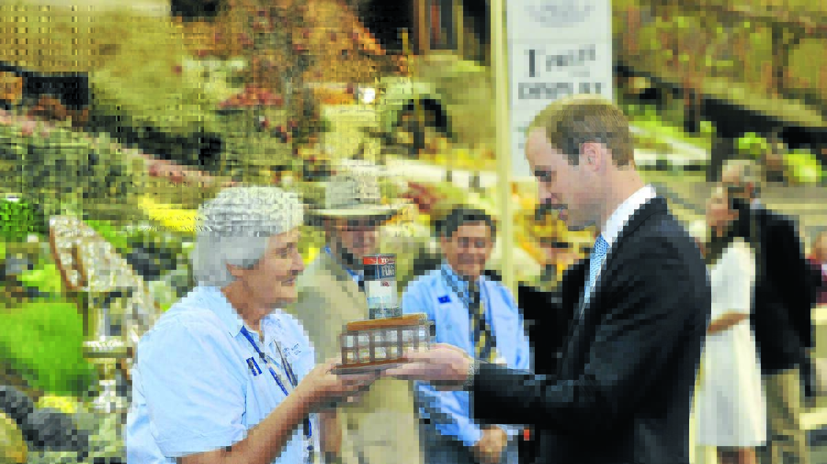 REGAL TOUCH: Glen Innes woman Lyn Cregan shows Prince William the coveted ‘beer can trophy’ at the Royal Easter Show on Good Friday. Photo: AUSPIC
