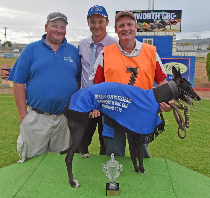 Charles Northfield holds Porky Teller after her Tamworth Cup win on Saturday, alongside sponsor Anthony Mabbott (Mikeloren Patisserie) and  Tamworth Greyhound Racing Club  president Robert Munn.  Photo: Geoff O’Neill 020515GOG04